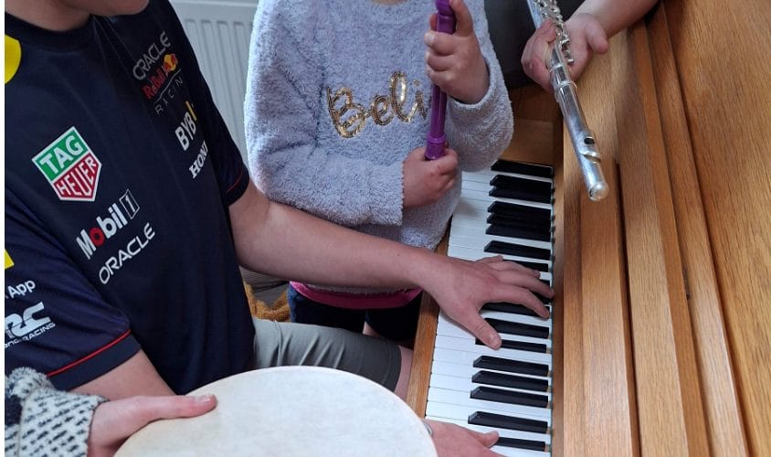 Close up shot of children playing instruments.